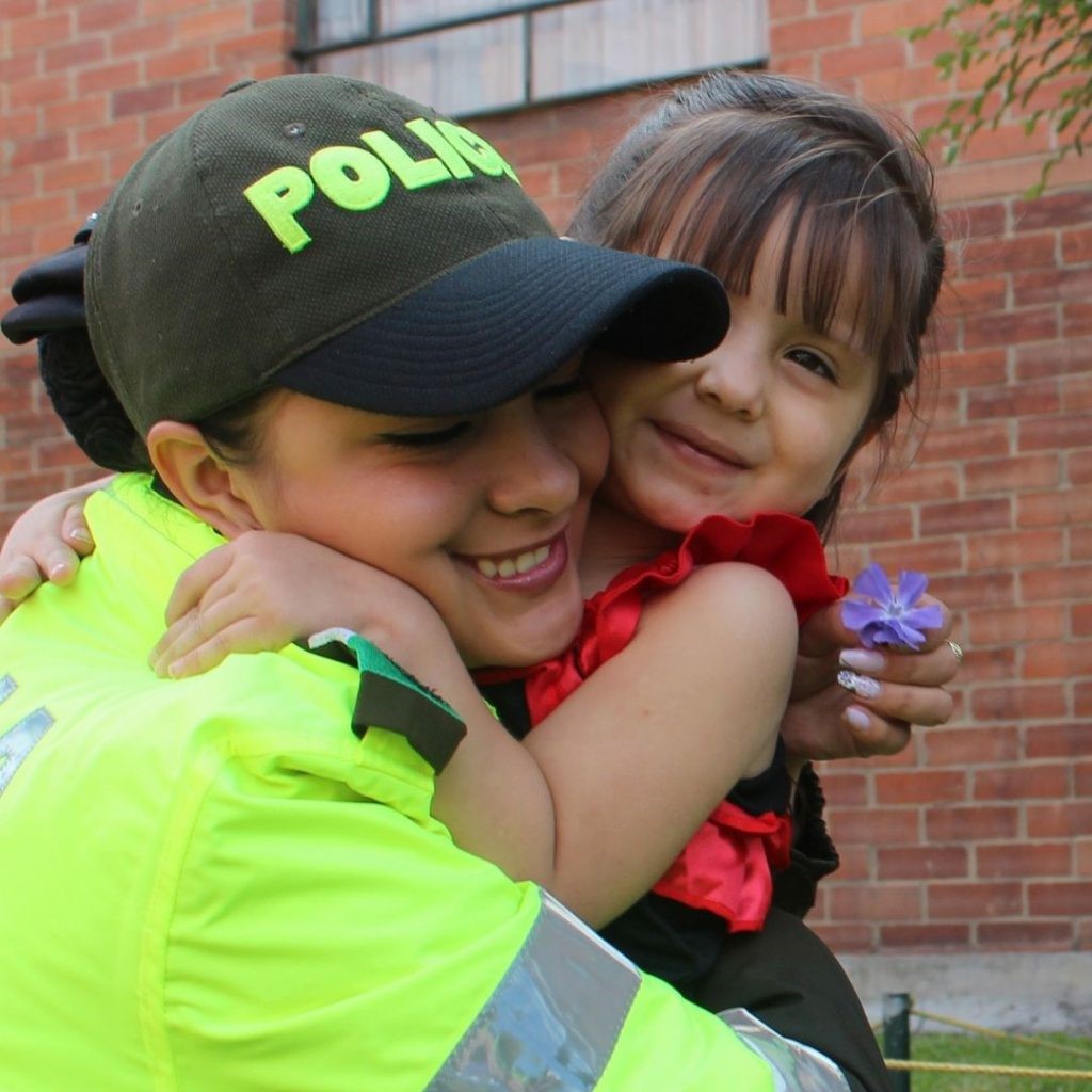 Girl and police women hugging